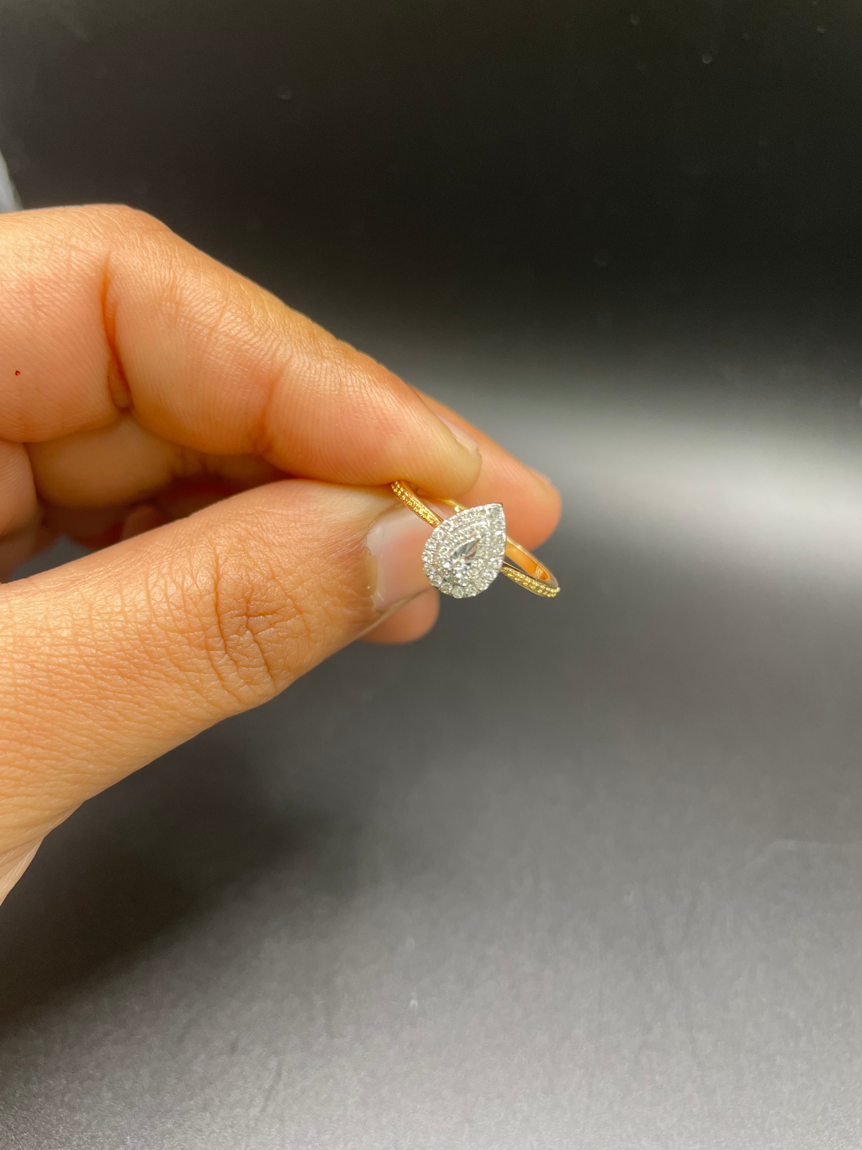 18KT gold drop shaped ring with diamonds